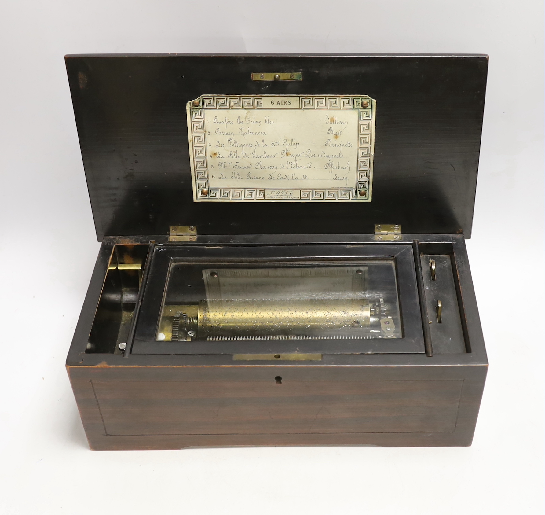 An inlaid rosewood cased musical box, single cylinder with a 56 note comb (one tooth broken and missing) playing six airs, tune list on underside of lid, 35 x 13 x 17.5cm